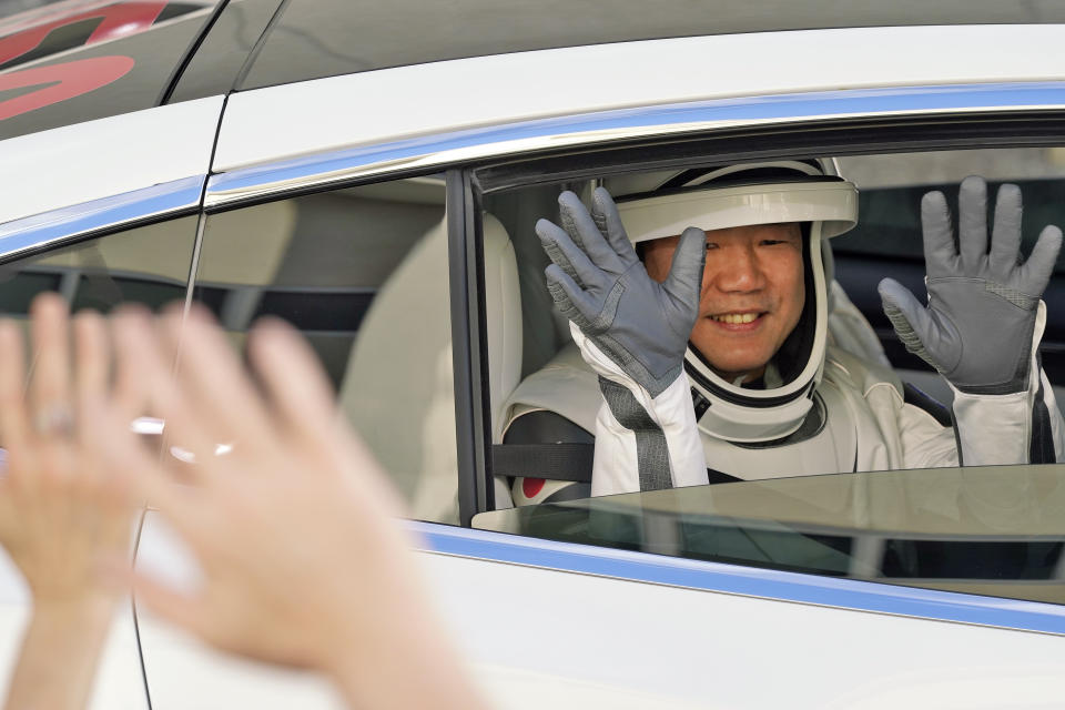 Japan Aerospace Exploration Agency astronaut Soichi Noguchi waves to family members as he leaves the Operations and Checkout Building with fellow crew members for a trip to Launch Pad 39-A and planned liftoff on a SpaceX Falcon 9 rocket with the Crew Dragon capsule on a six-month mission to the International Space Station Sunday, Nov. 15, 2020, at the Kennedy Space Center in Cape Canaveral, Fla. (AP Photo/John Raoux)