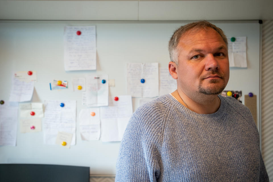 Konstantin Gudauskas, a Kazakh citizen and former journalist and human rights activist living in exile in Ukraine, poses for a photo in front of pieces of paper with the names and details of 203 Ukrainian citizens he rescued from behind Russian frontlines north of the capital on April 30, 2022 in Kyiv, Ukraine.