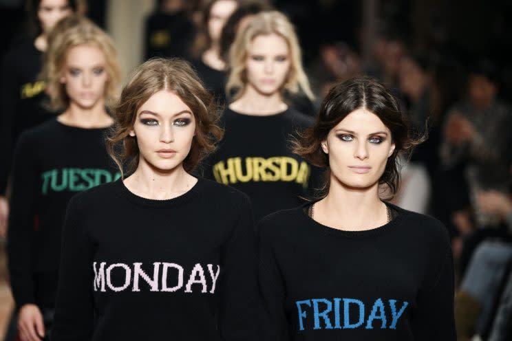 Models Gigi Hadid and Isabeli Fontana walk the Alberta Ferretti Fall/Winter 2017 show wearing “Monday” and “Friday” sweaters. (Photo: Getty Images)