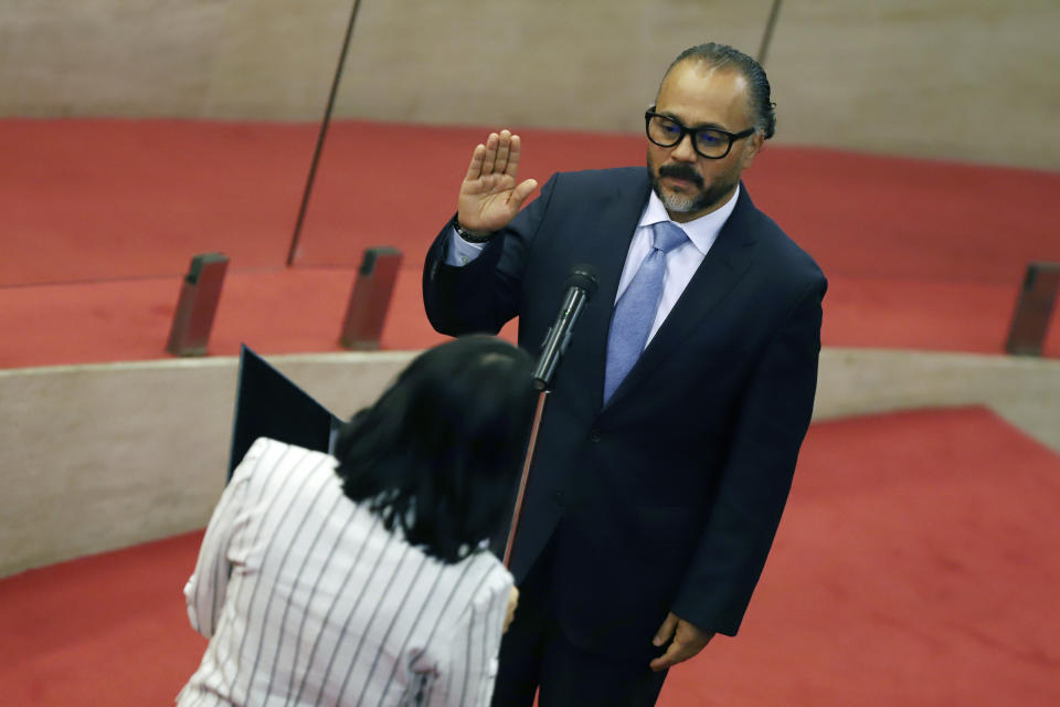 New Ideas party lawmaker Ernesto Castro is sworn-in as president of the El Salvador's Congress in San Salvador, El Salvador, Saturday, May 1, 2021. For the first time in three decades the traditional conservative and leftist parties have been sidelined by a resounding electoral defeat, clearing the way for President Nayib Bukele's party to help him advance his agenda. (AP Photo/Salvador Melendez)