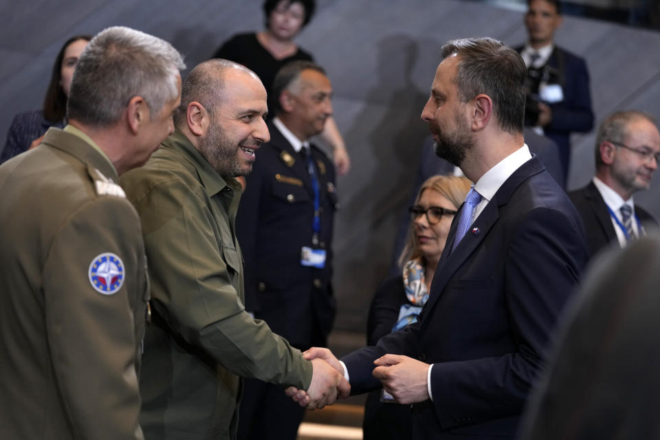 Ukraine's Defense Minister Rustem Umerov, center left, shakes hands with Poland's Defense Minister Wladyslaw Kosiniak-Kamysz, center right, during a meeting of the NATO-Ukraine council in defense ministers format at NATO headquarters in Brussels, Thursday, June 13, 2024. NATO defense ministers gathered Thursday hoping to agree on a new plan to provide long-term security assistance and military training to Ukraine, after Hungary promised not to veto the scheme as long as it's not forced to take part. (AP Photo/Virginia Mayo)