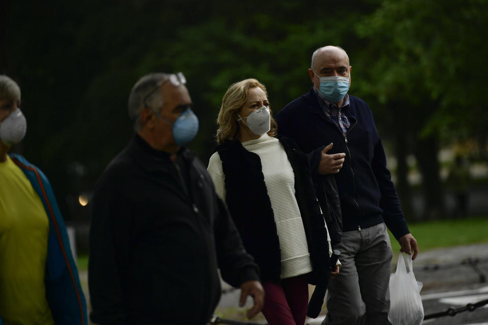 People wearing face masks to protect against coronavirus exercise along Vuelta del Castillo park, in Pamplona, northern Spain, Saturday, May 2, 2020. Spain relaxed its lockdown measures Saturday, allowing people of all ages to leave their homes for short walks or exercise for the first time since March 14. (AP Photo/Alvaro Barrientos)