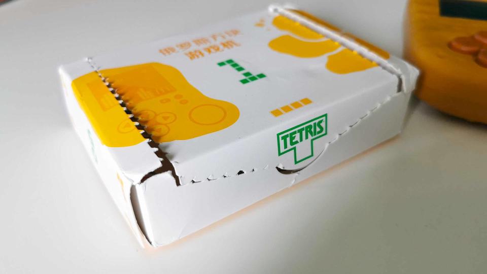 Mcdonalds Mcnugget handheld box sitting on white desk with Tetris logo on front side