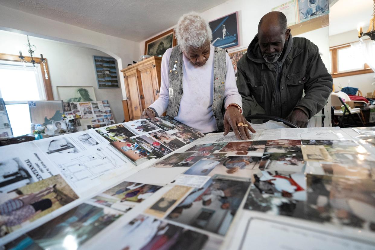 Bea Douglas Murphy and her youngest son Julian Murphy go through old photos and documents that Douglas Murphy has collected over the years. Douglas Murphy grew up in the nearby Burnside Heights neighborhood, a Black neighborhood that began in 1907 and is believed to have been host to some formerly enslaved people and their descendants.