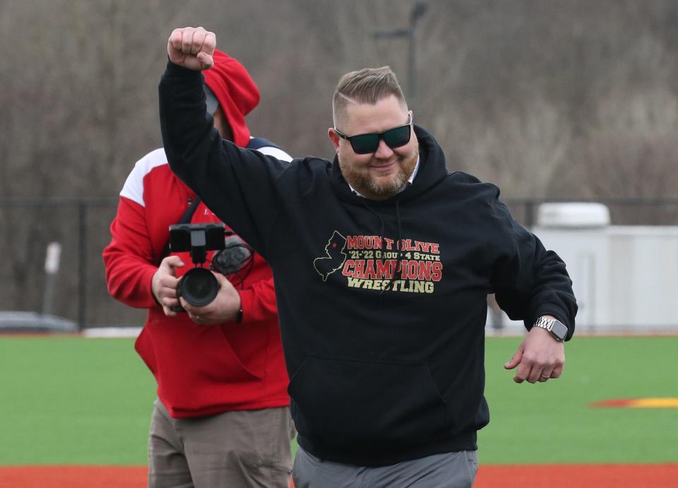 Mt. Olive School Superintendent Robert Zywicki throws out the first pitch as Mt. Olive High School unveiled and played their first game at their new baseball complex against West Morris on April 27, 2022.