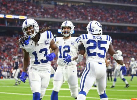 Jan 5, 2019; Houston, TX, USA; Indianapolis Colts wide receiver T.Y. Hilton (13), quarterback Andrew Luck (12) and running back Marlon Mack (25) celebrate a second quarter touchdown against the Houston Texans during the AFC Wild Card at NRG Stadium. Mandatory Credit: Mark J. Rebilas-USA TODAY Sports