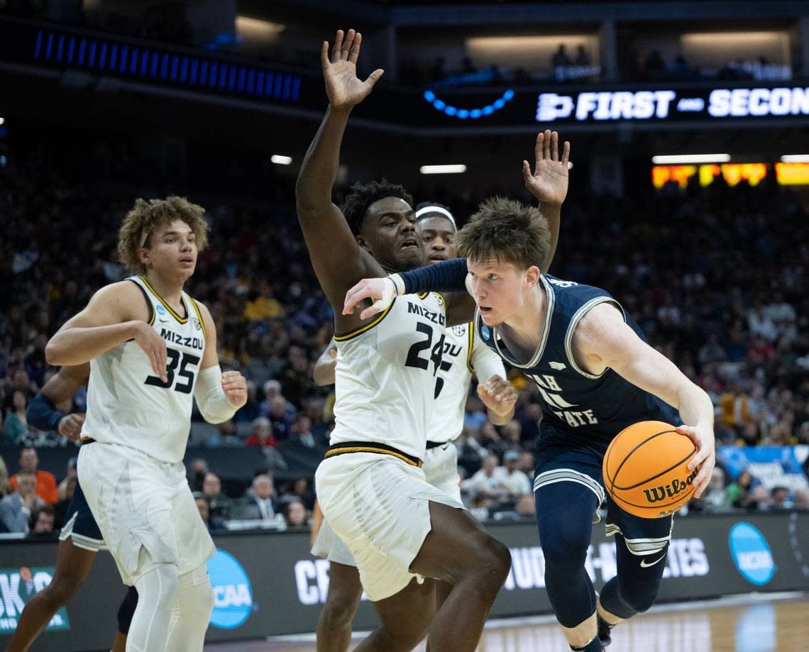 Missouri Tigers guard Kobe Brown (24) defends against Utah State Aggies guard Max Shulga (11) during a game for the NCAA Tournament at Golden 1 Center in Sacramento, Thursday, March 16, 2023.