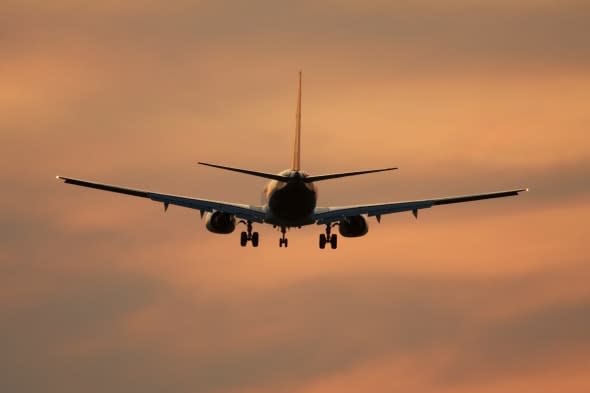holiday scams on the increase airliner against sunset sky