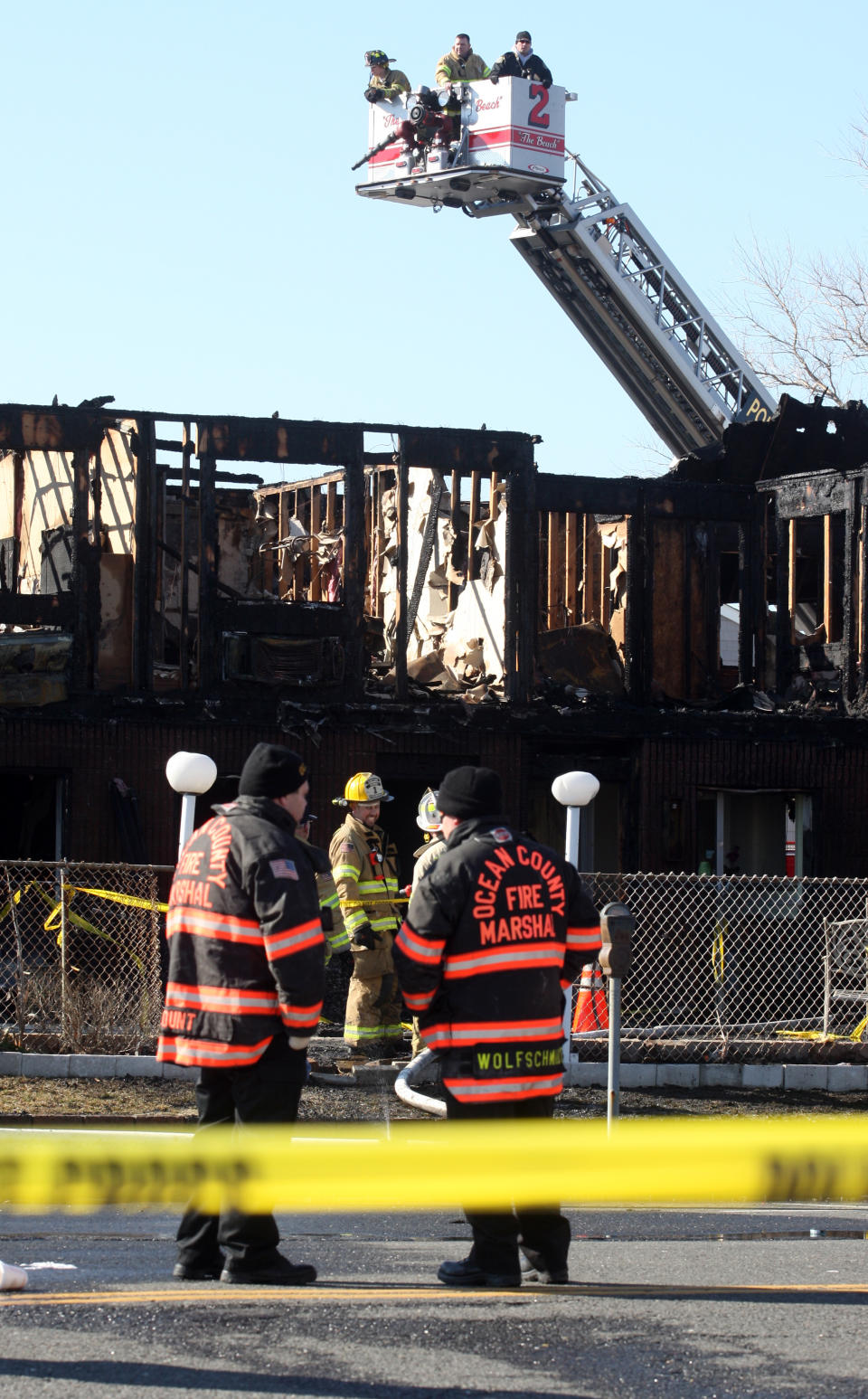 Firefighters investigate an early morning fire at the Mariner's Cove Hotel in Point Pleasant Beach, N.J. on Friday, March 21, 2014. (AP Photo/David Gard)