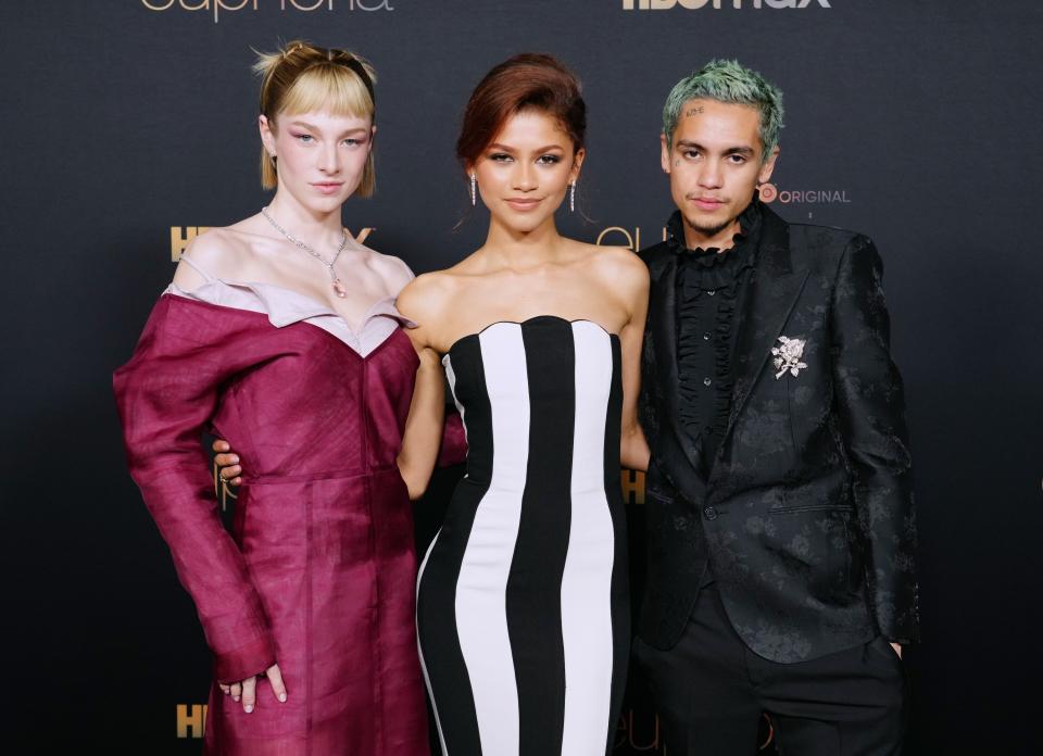 Hunter Schafer, Zendaya, and Dominic Fike posing for photographers at an event for Euphoria Season 2