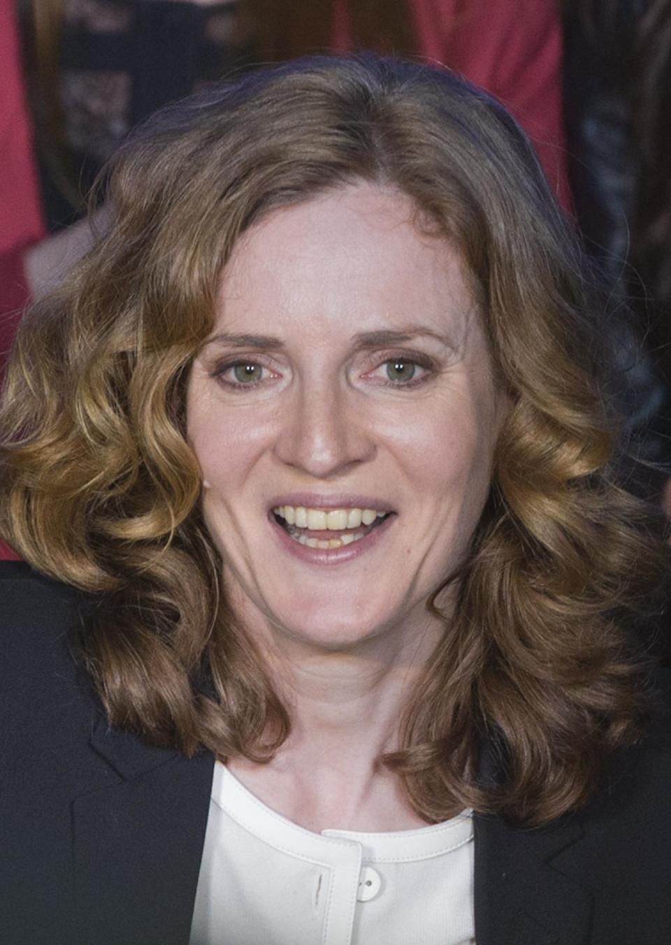 Nathalie Kosciusko-Morizet, the conservative UMP political party candidate for the upcoming election for the mayor of Paris, smiles during a campaign meeting in Paris, Thursday, March 27, 2014. France's unpopular president faces a moment of truth after his Socialist Party suffered a drubbing at the polls and the far-right made advances across the country. The second round of municipal elections takes part on March 30 throughout France. (AP Photo/Jacques Brinon)