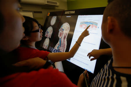 First-year medical student Doris Chan makes a point as she participates with classmates in the virtual anatomy class at the UNLV School of Medicine in Las Vegas, Nevada, U.S., August 27, 2018. Picture taken August 27, 2018. REUTERS/Mike Blake