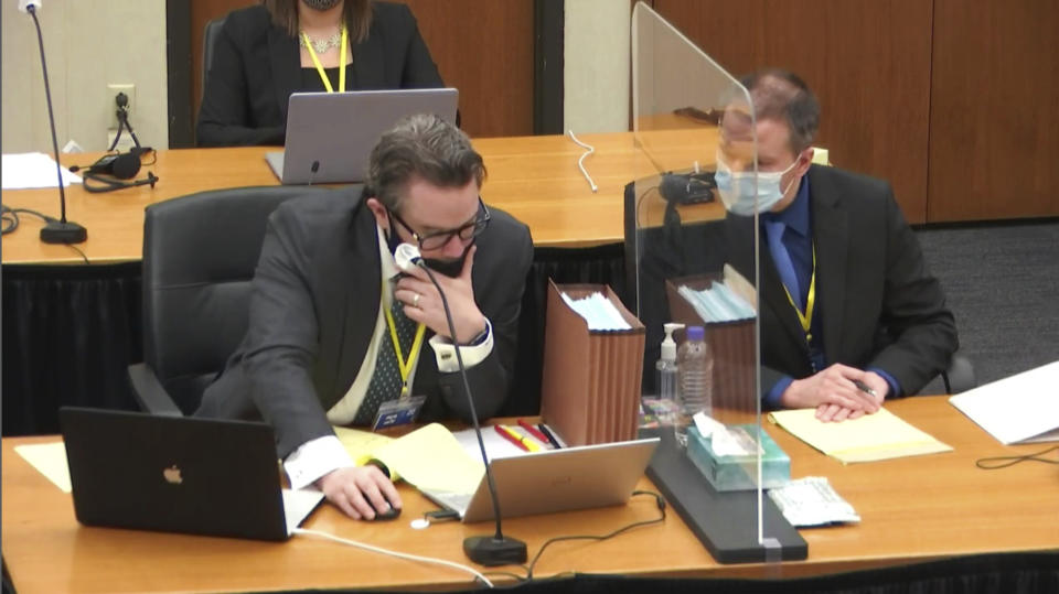 In this image from video, defense attorney Eric Nelson, left, with defendant former Minneapolis police Officer Derek Chauvin, prepares to question a witness as Hennepin County Judge Peter Cahill presides, Wednesday, April 7, 2021, in the trial of Chauvin at the Hennepin County Courthouse in Minneapolis, Minn. Chauvin is charged in the May 25, 2020 death of George Floyd. (Court TV via AP, Pool)