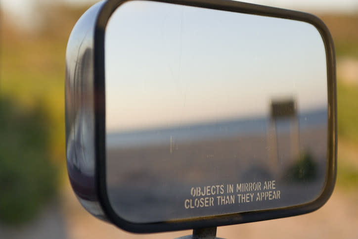 A mirror reads, "Objects in mirror are closer than they appear"