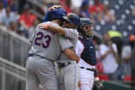 New York Mets' Francisco Lindor, center, celebrates his two-run home run with David Peterson (23) during the fifth inning of the first baseball game of a doubleheader, Saturday, June 19, 2021, in Washington. At right is Washington Nationals catcher Alex Avila. This is a makeup of a postponed game from April 1. (AP Photo/Nick Wass)
