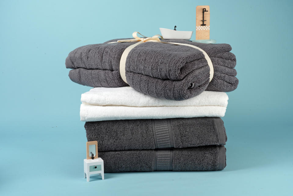 a selection of quick-dry towels with miniature bathroom furniture