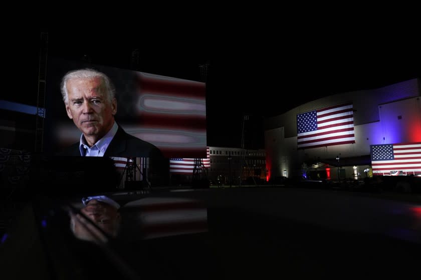 Images of Democratic presidential candidate former Vice President Joe Biden are shown on a screen outside the venue where Biden will speak later tonight, during the final day of the Democratic National Convention, Thursday, Aug. 20, 2020, at the Chase Center in Wilmington, Del. (AP Photo/Carolyn Kaster)