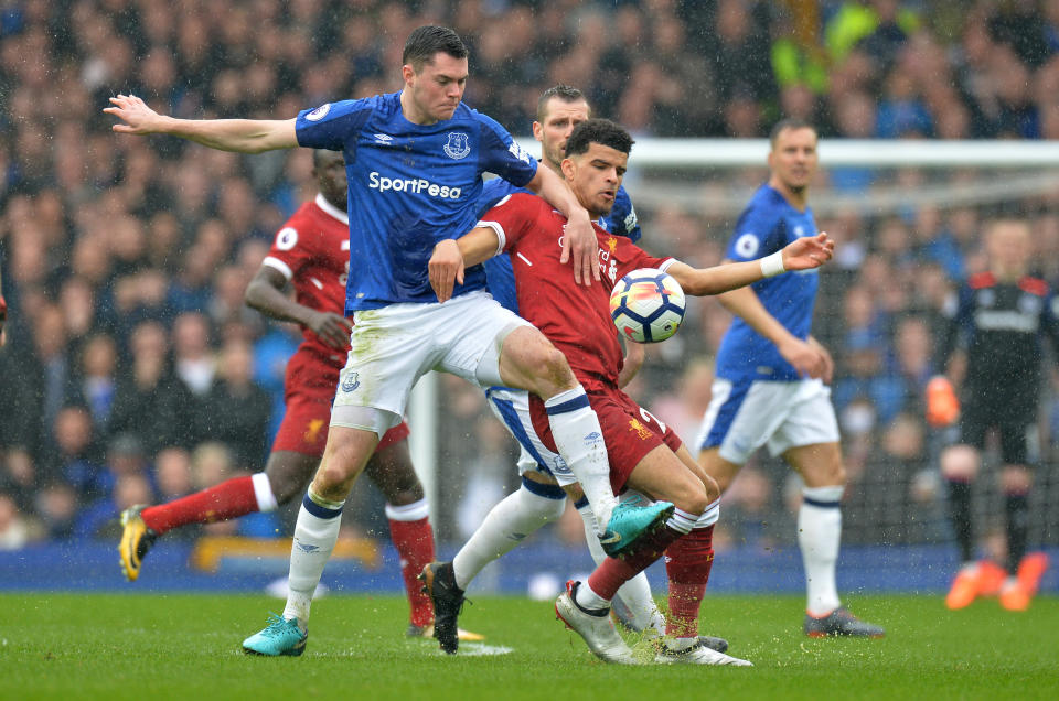 <p>Liverpool’s Dominic Solanke is held back by verton’s Michael Keane </p>