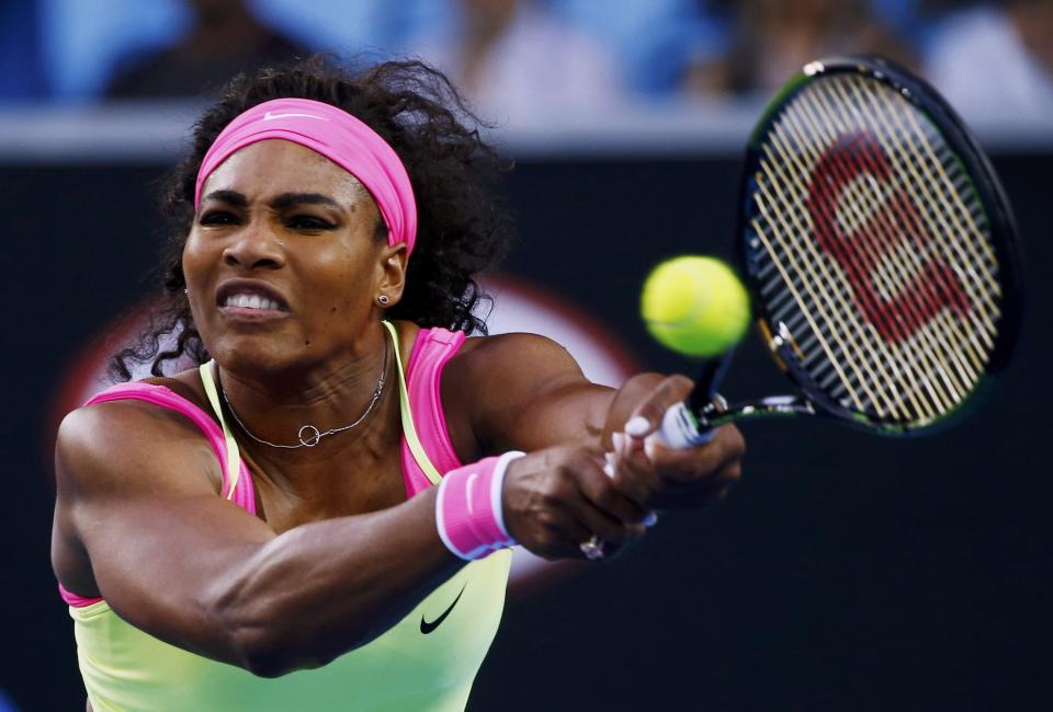 Williams of the U.S. hits a return to Van Uytvanck of Belgium during their women's singles first round match at the Australian Open 2015 tennis tournament in Melbourne