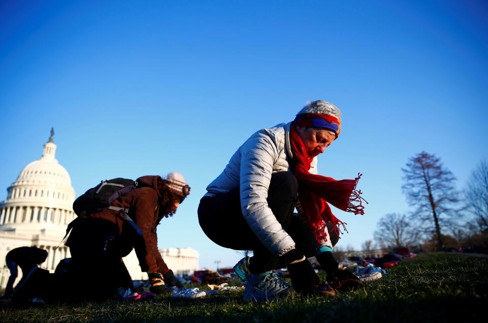 <p>Activists install 7000 shoes on the lawn in front of the U.S. Capitol on Capitol Hill in Washington, U.S. March 13, 2018. Organizers said the installation represents the number of lives lost since the shooting at Sandy Hook elementary in Newtown, Connecticut. (Photo: Eric Thayer/Reuters) </p>