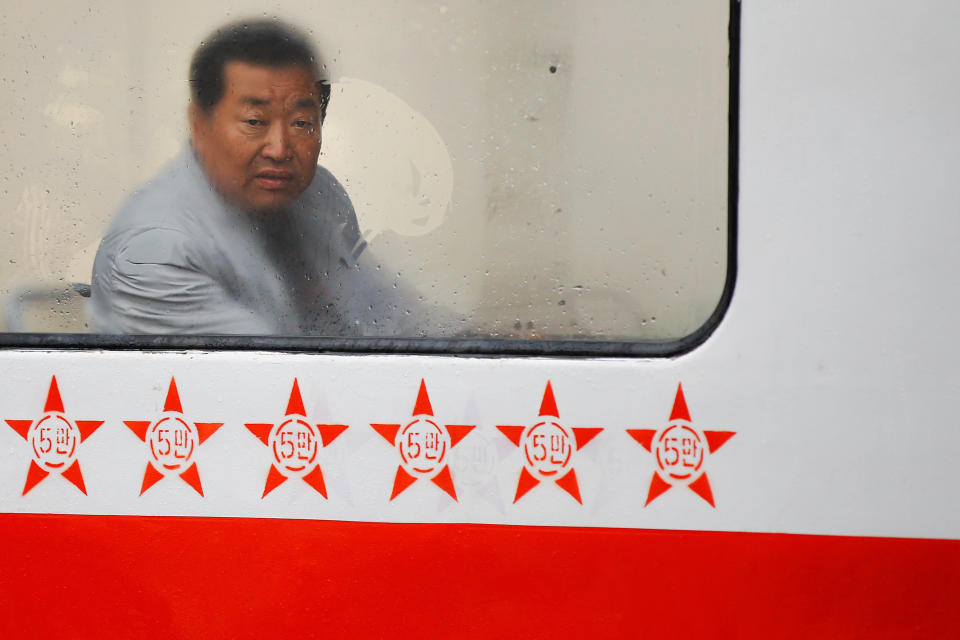 A man looks through the foggy window of a tram on a rainy day in central Pyongyang, April 14, 2017.