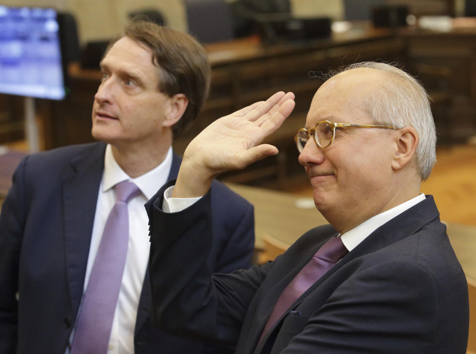 Lawyers of former Austrian Chancellor Sebastian Kurz, Otto Dietrich, left, and Walter Suppan, right, wait in the courtroom for the begin of his trial in Vienna, Austria, Wednesday, Oct. 18, 2023. Kurz is charged with making false statements to a parliamentary inquiry into alleged corruption in his first government. (AP Photo/Heinz-Peter Bader)