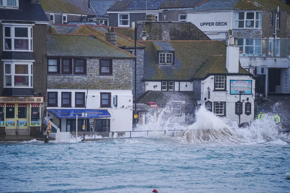 ST IVES, ENGLAND - APRIL 09: Waves strike the harbourside on April 09, 2024 in St Ives, Cornwall, England. On Monday, the Met Office issued severe weather warnings for wind across the southern and western coasts of England and Wales, effective until Tuesday afternoon. This follows the turbulent weather over the weekend, when Storm Kathleen, combined with high tides, generated massive waves along the Cornish coast. (Photo by Hugh Hastings/Getty Images)