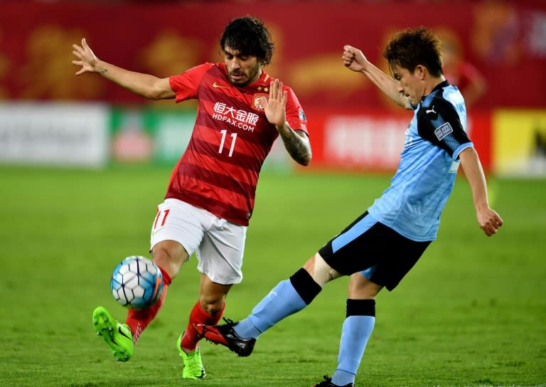 Ricardo Goulart (L) of China's Guangzhou Evergrande vies with Noborizato Kyohei of Japan's Kawasaki Frontale during their AFC Champions League group match in Guangzhou, in China's Guangdong province on March 14, 2017