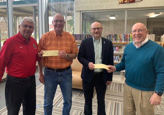 Alliance Lions Club president Bill Prueter, left, presents a $1,000 check to Alliance Community Pantry board president Bruce Helsel, second from left, as Rodman Public Library Director Eric Taggart, second from right, accepts a $1,000 check for large print books from Lions Club treasurer Jim Greiner, right.