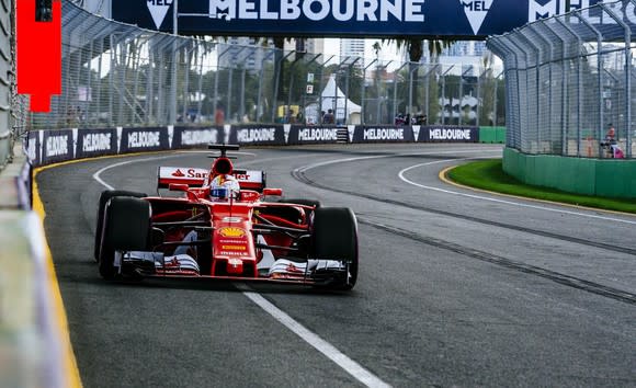 A Ferrari Formula 1 race car driven by Sebastian Vettel is shown on the racetrack in Melbourne, Australia.