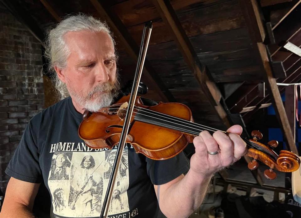 Larry Dickman rehearses with members of the Aaron Hymes Band. The Stark County-based Christian country band recently signed a Nashville-based record contract.