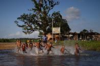 Children of the Karipuna indigenous people play at the Uaha village on the Jumina indigenous land, region near the mouth of the Amazon in Oiapoque