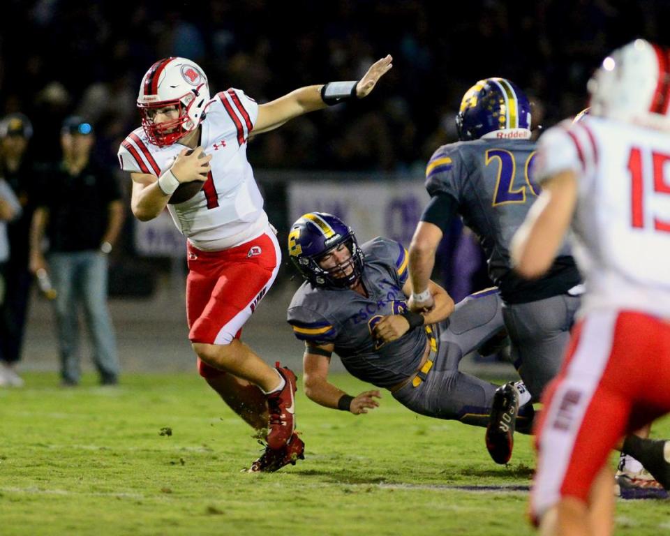 Ripon quarterback Ty Herrin (1) scrambles out of the pocket on a run during a game between Escalon High School and Ripon High School in Escalon, California on October 20, 2023. 