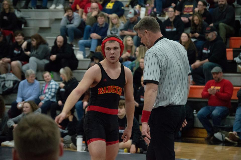 Joey Campbell wins a battle with teammate Lukas Strine for the 175-pound district title.