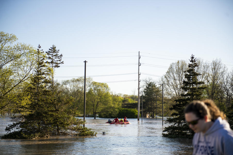 First responders from the sheriff's office survey the flooding in downtown Midland, Mich., on Wednesday, May 20, 2020. After the Edenville Dam failed and the Tittabawassee River flooded surrounding areas, many residents were urged to leave their homes. (Kaytie Boomer/The Bay City Times via AP)