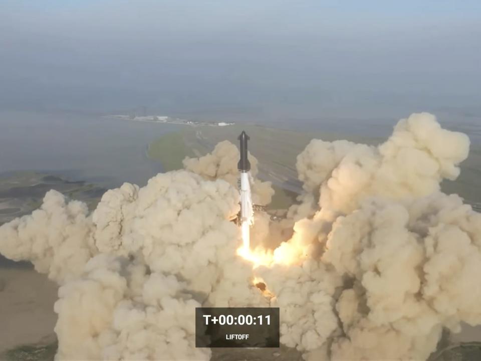 Starship black rocket lifts off from texas plains