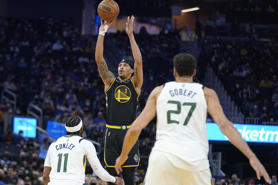 Golden State Warriors guard Damion Lee (1) shoots a 3-point basket over Utah Jazz guard Mike Conley (11) and center Rudy Gobert (27) during the first half of an NBA basketball game in San Francisco, Sunday, Jan. 23, 2022. (AP Photo/Jeff Chiu)