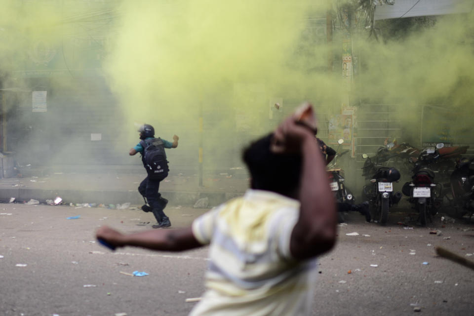 An activist of the Bangladesh Nationalist Party attacks a police officer during a protest in Dhaka, Bangladesh, Saturday, Oct. 28, 2023. Police in Bangladesh's capital fired tear gas to disperse supporters of the main opposition party who threw stones at security officials during a rally demanding the resignation of Prime Minister Sheikh Hasina and the transfer of power to a non-partisan caretaker government to oversee general elections next year. (AP Photo/Mahmud Hossain Opu)