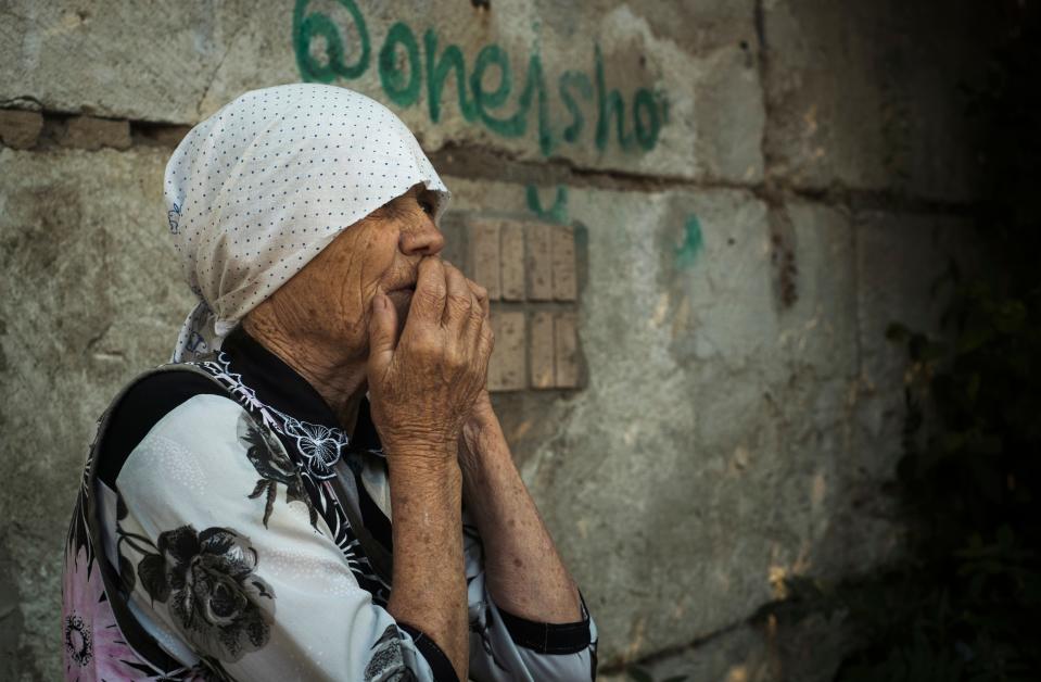 An elderly Ukrainian woman looks on after Russian shelling in Mykolaiv, Ukraine, Wednesday, June 29, 2022. 