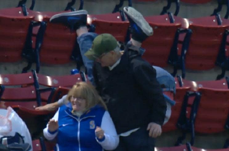 A fan tumbles in the upper deck at Fenway Park after missing a foul ball. (MLB.TV)