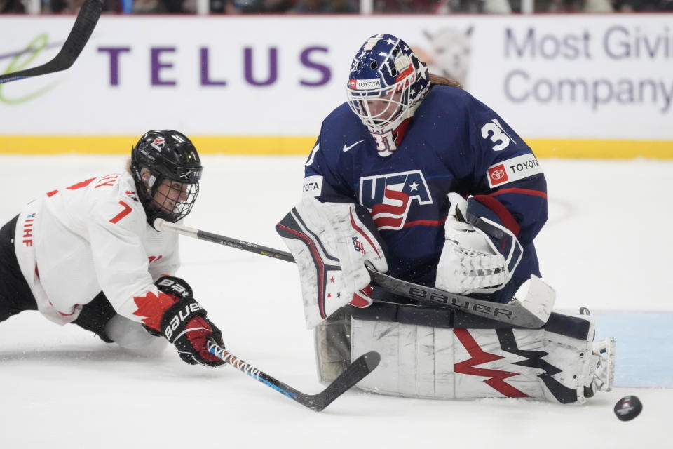 United States goaltender Aerin Frankel (31) makes a save as Canada forward Laura Stacey (7) tries to reach the puck during second period IHF Women's World Hockey Championship gold medal hockey action in Brampton, Ontario, Sunday, April 16, 2023. (Frank Gunn/The Canadian Press via AP)