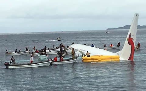 Local boats rescue passengers and crew from a 737 that ditched in the waters off the remote island of Chuuk, in Micronesia - Credit: James Yaingeluo/AFP
