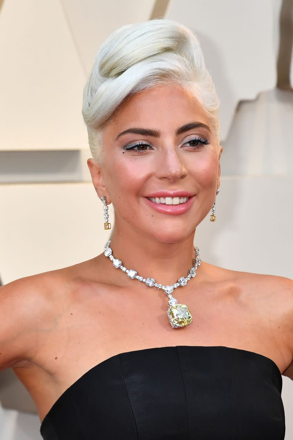 <p>A bronze Lady Gaga swept her hair into a voluminous updo that channeled Audrey Hepburn in <em>Breakfast at Tiffany's</em>. “Her makeup was all about being soft, fresh and young. We didn’t want anything to distract from this special moment,” said Sarah Tanno, celebrity makeup artist and Marc Jacobs Beauty ambassador. </p>