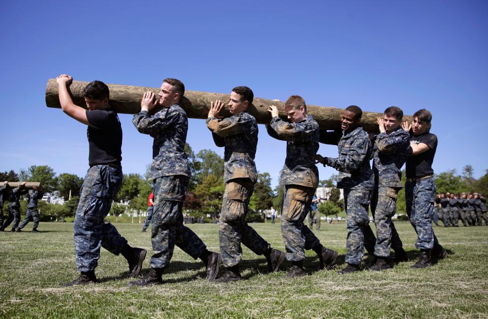 First-year midshipmen carry a log during Sea Trials, a day-long training exercise that caps off their plebe year at the U.S. Naval Academy in Annapolis, Md., May 16, 2017. The academy on April 15, 2019 confirmed it will not accept transgender students beginning with the 2020 school year.