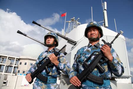 Soldiers of China's People's Liberation Army (PLA) Navy stand guard in the Spratly Islands, known in China as the Nansha Islands, February 10, 2016. REUTERS/Stringer