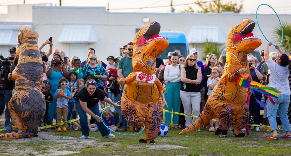 A T-Rex relay race at the Bay County Chamber of Commerce block party Thursday.