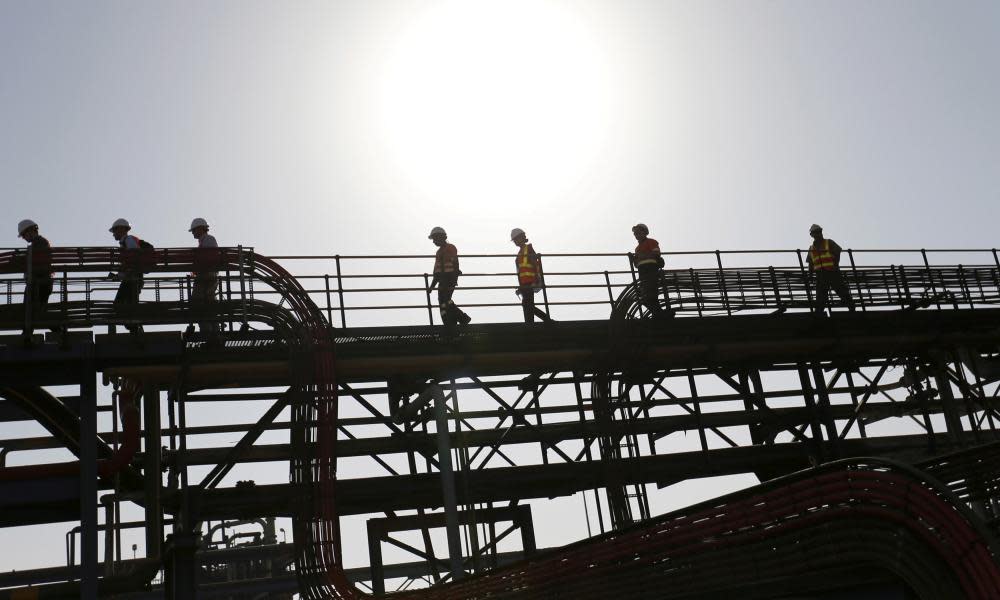 Workers and visitors walk within the processing plant at the Bisha Mining Share Company in Eritrea, operated by Canadian company Nevsun Resources