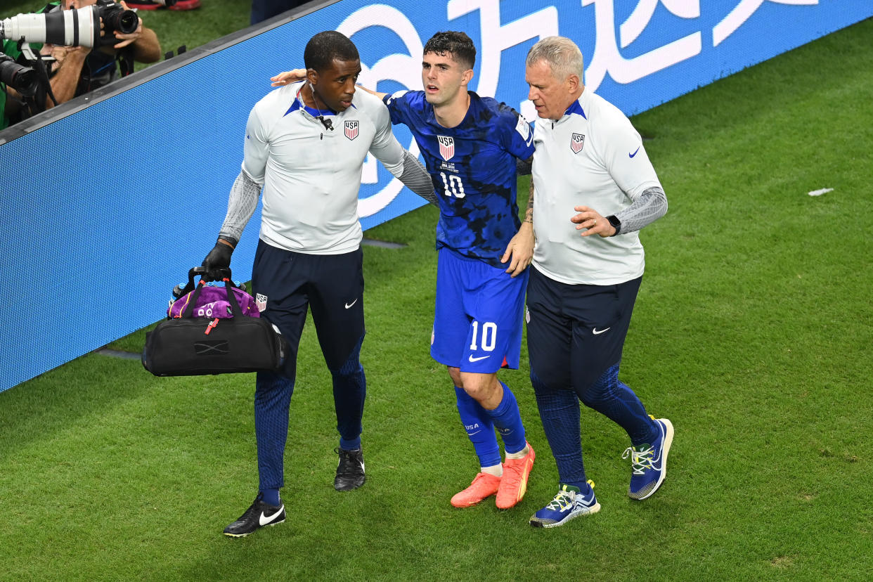 DOHA, QATAR - NOVEMBER 29: Christian Pulisic of United States receives medical treatment after scoring their side's first goal during the FIFA World Cup Qatar 2022 Group B match between IR Iran and USA at Al Thumama Stadium on November 29, 2022 in Doha, Qatar. (Photo by Claudio Villa/Getty Images)