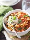 <p>Hearty lentils and tender noodles are simmered in chunky a tomato broth and topped with creamy vegan ricotta to make this cozy soup. </p><p>Get the recipe from <a href="https://www.connoisseurusveg.com/slow-cooker-vegan-lasagna-soup/" rel="nofollow noopener" target="_blank" data-ylk="slk:Connoisseurus Veg;elm:context_link;itc:0;sec:content-canvas" class="link ">Connoisseurus Veg</a>.</p>