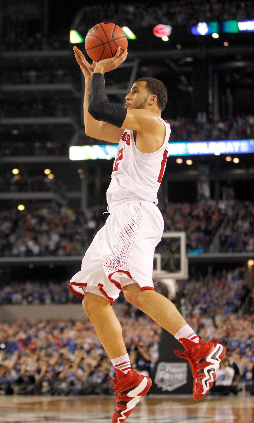 Wisconsin Badgers guard Traevon Jackson (12) attempts a shot that would win the game for Wisconsin at the NCAA Final Four Semifinals, Saturday, April 5, 2014, at AT&T Stadium in Arlington, Texas.